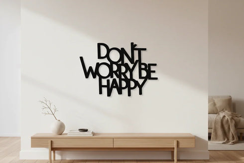 Modern minimal living room with wooden console table, decorative vase, and black wooden wall art saying Don't Worry Be Happy