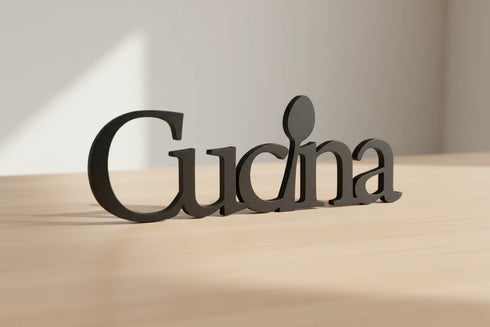 Black wooden kitchen decoration with the word 'Cucina' and a spoon detail on a light wooden surface