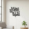Modern home interior with black wooden Italian wall decoration saying 'Mi lasci sempre un buon sapore', light grey armchair, and green potted plant