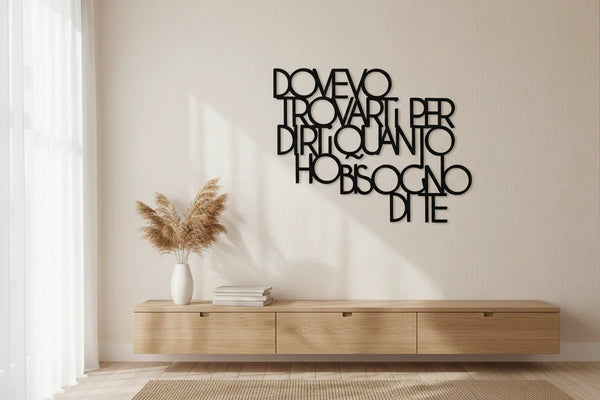 Minimalist living room with wooden wall-mounted decor featuring Italian text, wooden cabinet, vase with pampas grass