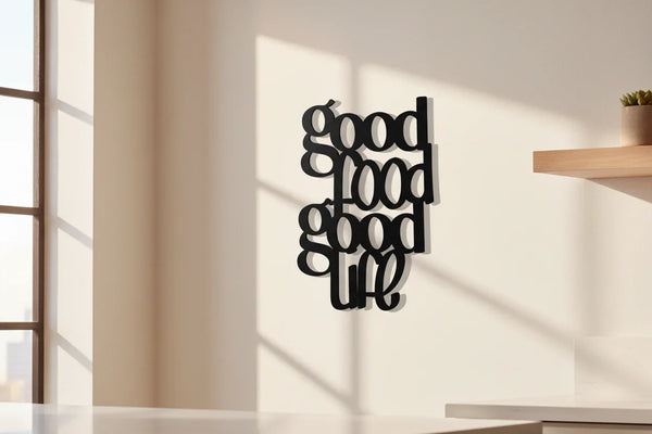Black wooden wall decor with text 'good food good life' in bright modern kitchen near window and shelf
