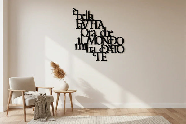 Minimalist living room with wooden armchair, side table, pampas grass vase, and black Italian wall decor