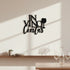 Black wooden wall decor reading 'In Vino Veritas' with wine glass silhouette, minimalist home setting