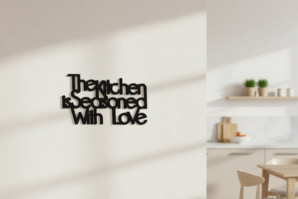 Black wooden wall decor reading The kitchen is seasoned with love in modern kitchen setting