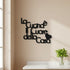 Black wooden wall decor reading 'La Cucina è il Cuore della Casa' with a heart shape on beige kitchen wall above white marble countertop with green basil plant