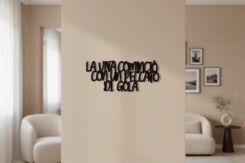 Black wooden wall decor with Italian phrase 'La vita comincia con un peccato di gola' in modern living room