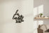Black wooden decorative wall art with Italian text 'lu jentu du sule lu mare' in modern living room