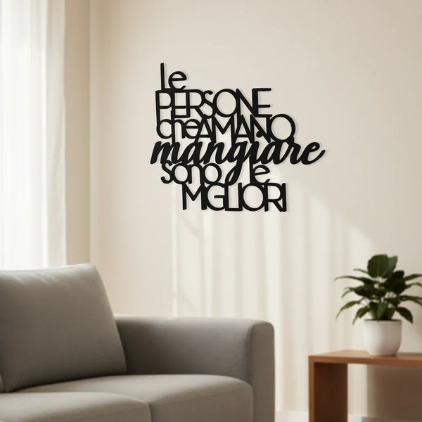 Black wooden wall decoration with Italian text about food lovers in modern living room with grey sofa and potted plant