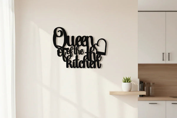 Black wooden wall art reading "Queen of the kitchen" with oven mitt design in a modern kitchen