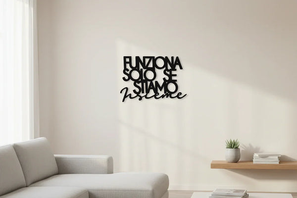Minimalist living room with wooden wall decoration saying 'Funziona solo se stiamo insieme', modern sofa, potted plant, and floating shelf