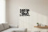 Minimalist living room with wooden wall decoration saying 'Funziona solo se stiamo insieme', modern sofa, potted plant, and floating shelf