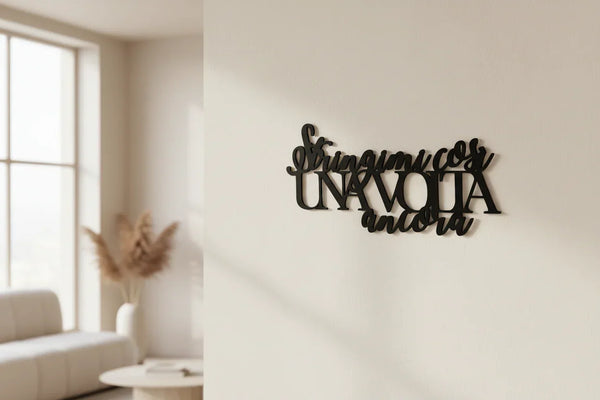 Black wooden wall decoration with Italian text 'stringimi cosi una volta ancora' in a minimalist living room
