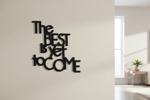 Black wooden wall decoration with inspirational quote The Best Is Yet To Come in modern living room
