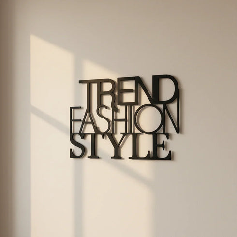 Modern black metal wall decor with overlapping words Trend Fashion Style on beige wall