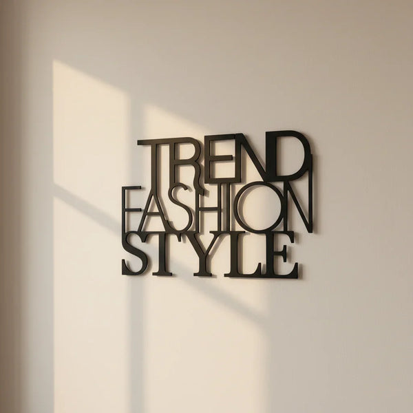 Modern black metal wall decor with overlapping words Trend Fashion Style on beige wall