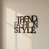 Modern black metal wall decor with overlapping words Trend Fashion Style on beige wall