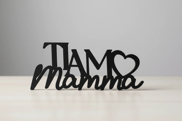Black wooden decorative sign reading Ti Amo Mamma with heart shape on wooden surface